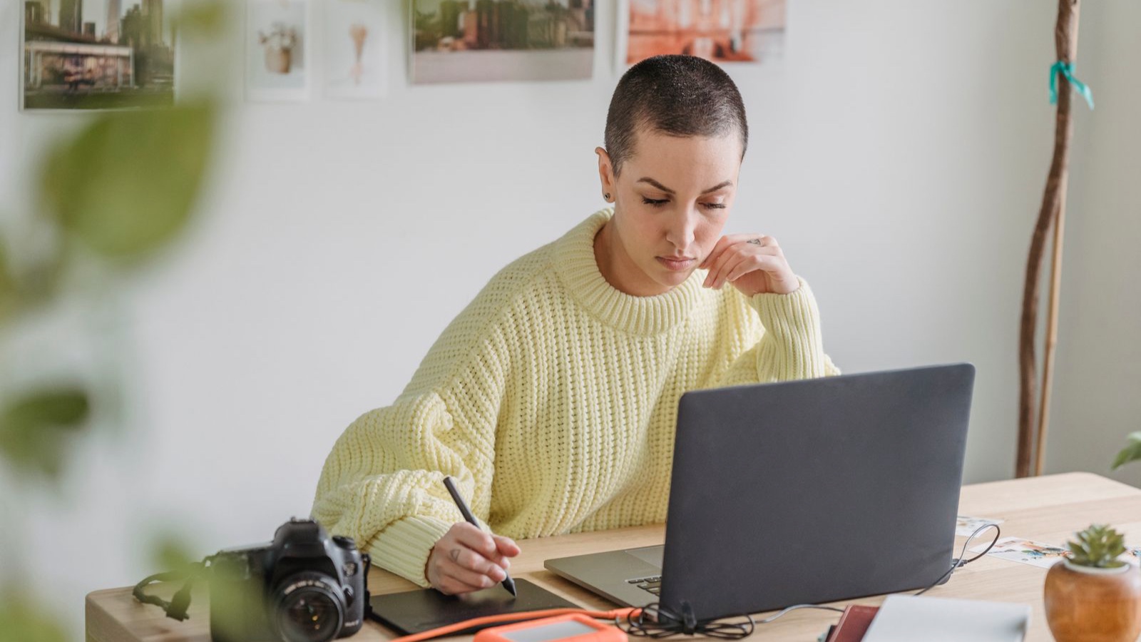 Web Design in Ataşehir: Planning a Corporate Website Project Focused young female in casual sweater working on modern netbook and drawing on graphic tablet while sitting at desk