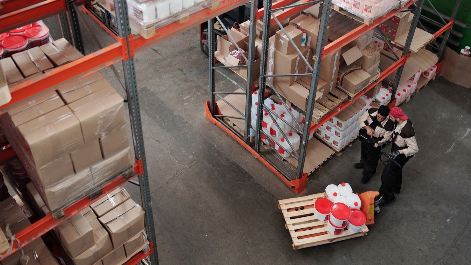 B2B Ecommerce Software: Dealer Prices, Permissions and Approval Rules Workers checking products and shipments in a warehouse