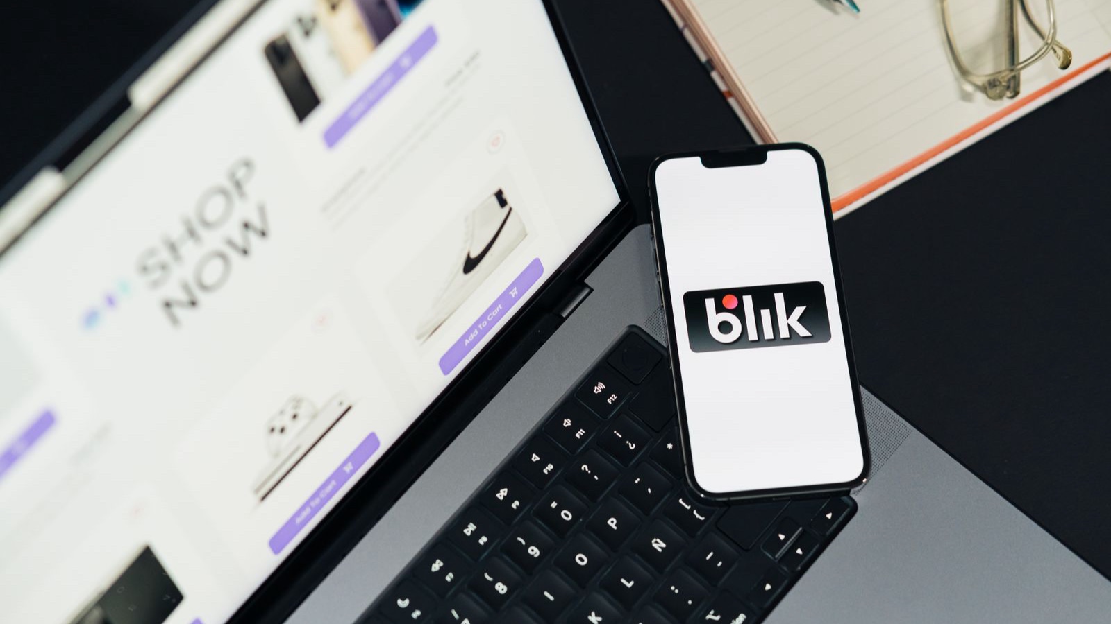 Packaged Ecommerce or Bespoke Development: How to Decide Online store on a laptop beside a phone displaying a payment option