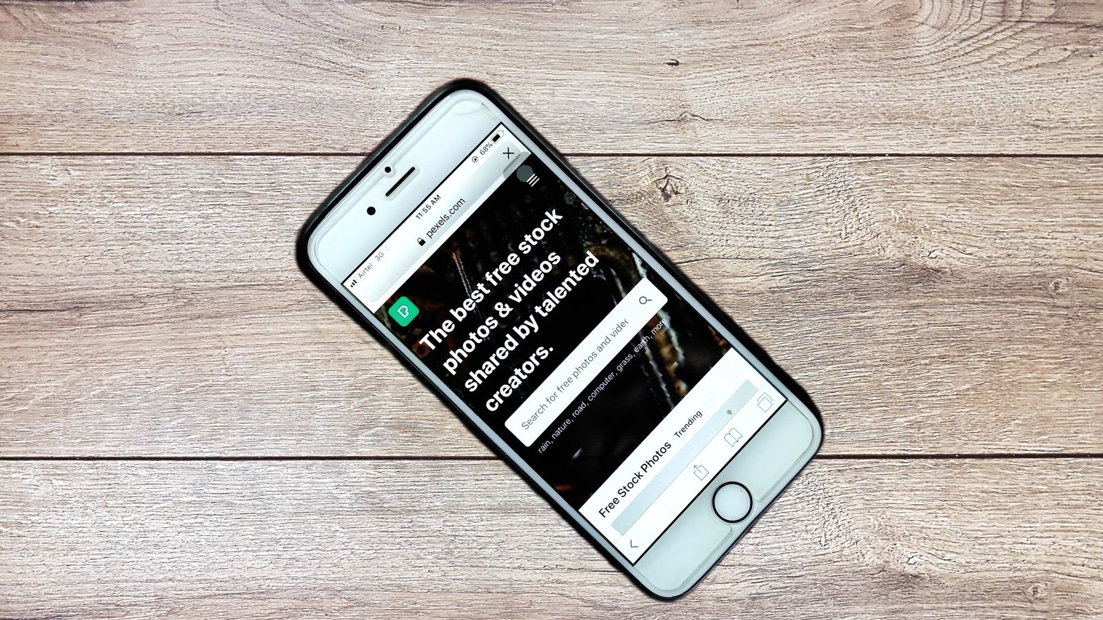 Mobile-Friendly Web Design: Real Tasks on Small Screens Top view contemporary mobile phone with opened website on screen placed on wooden table