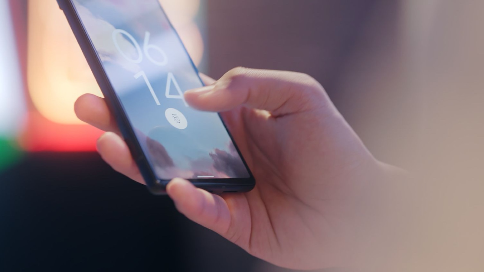 Social Media Account Security: Organise Agency Access and Ownership A hand holding a phone displaying a fingerprint lock screen
