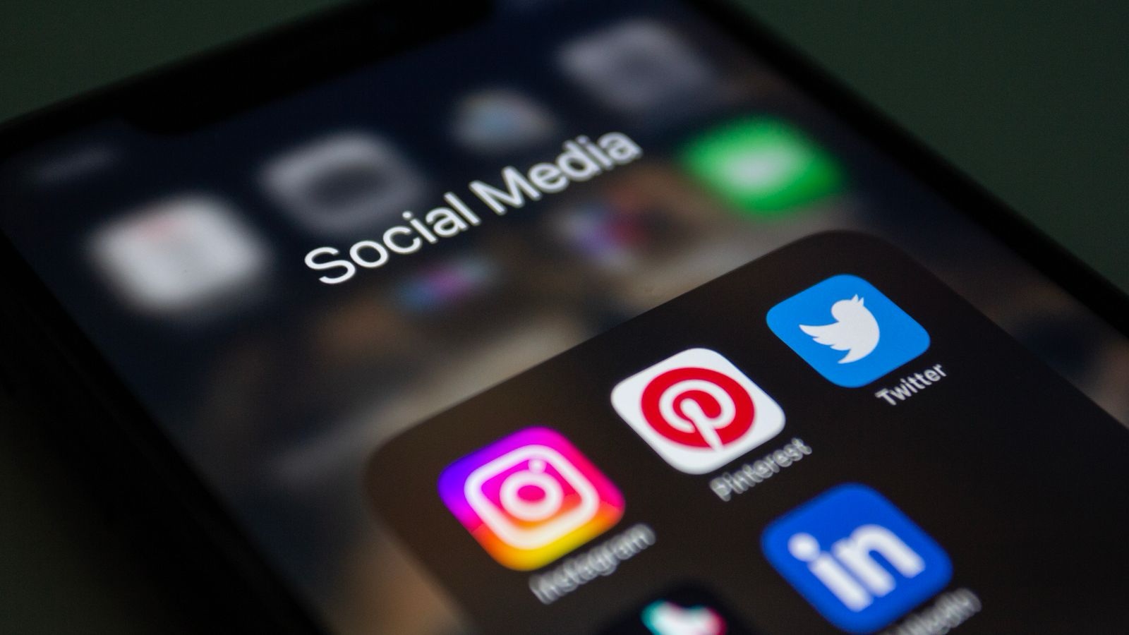 Maintaining brand consistency in social media templates A folder of social media applications on a smartphone screen