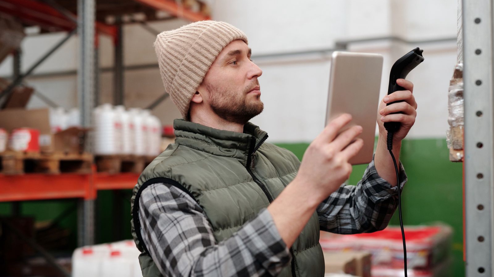 Inventory Synchronisation: Where Should Available Stock Be Calculated? Warehouse worker checking stock with a handheld terminal