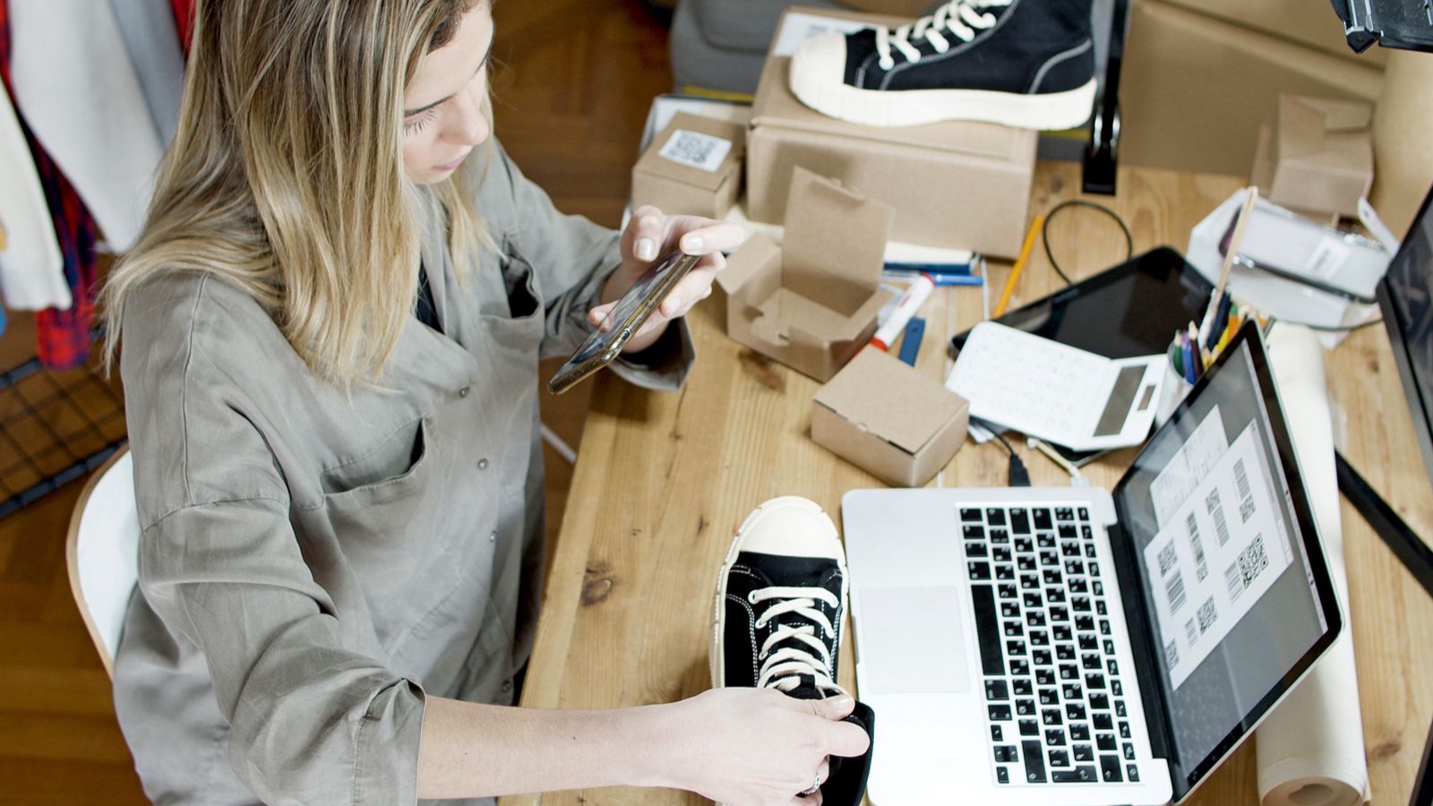 Product Page Optimisation: Answer the Questions Behind a Purchase Online seller preparing a product photograph of a sneaker