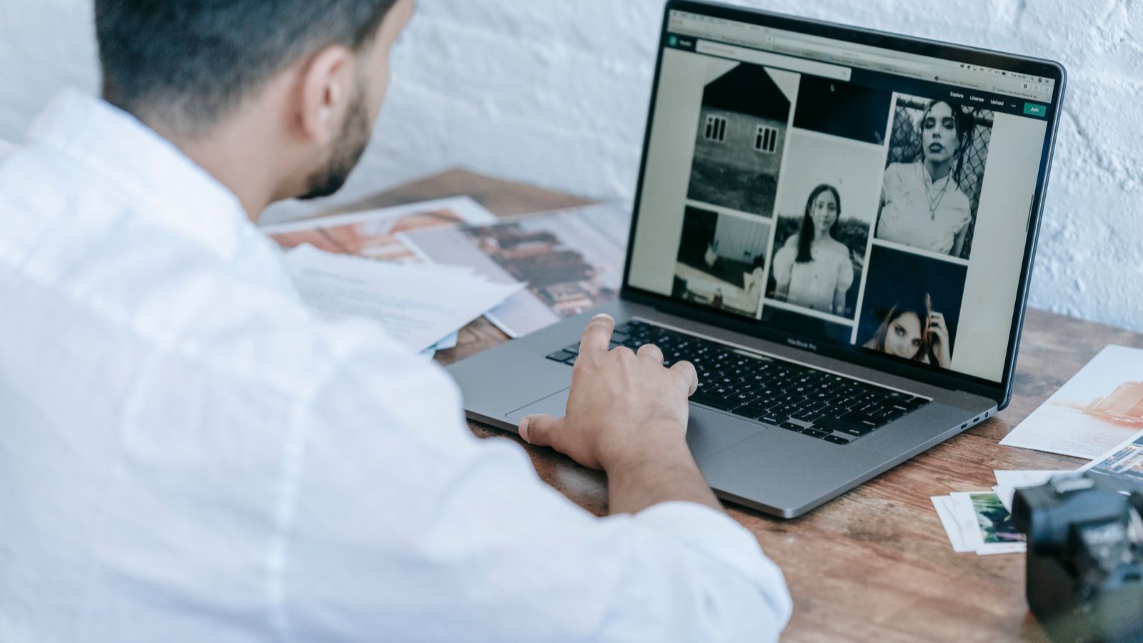 Web Image Optimisation: Reduce Delivery Cost Without Losing Meaning Side view of crop bearded male photographer using laptop while preparing pictures for publishing in modern workplace