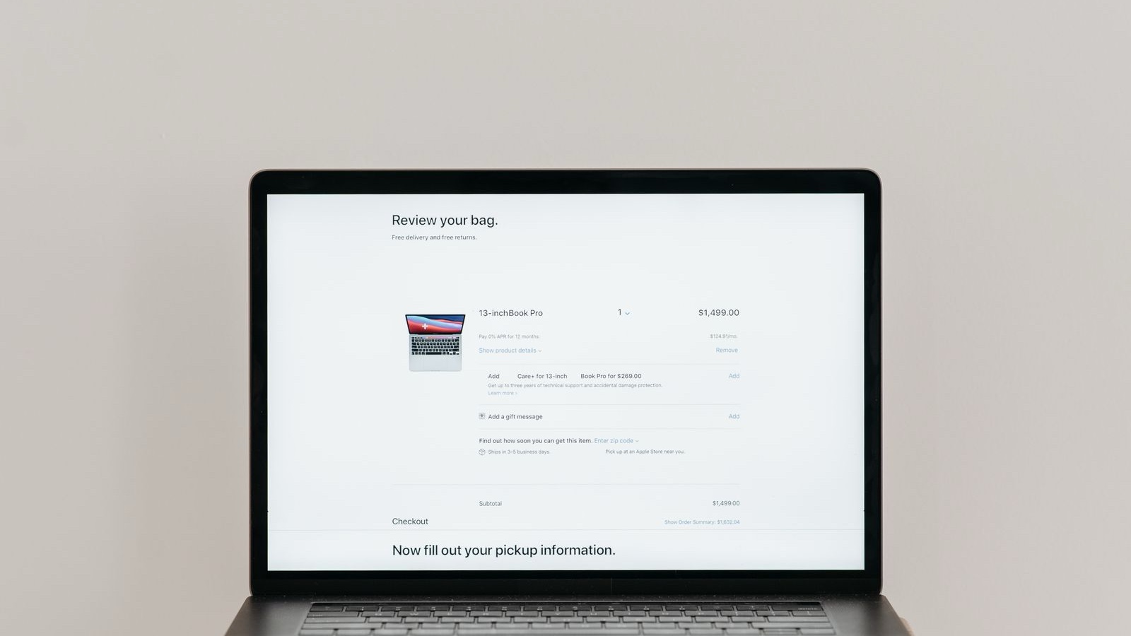 Minimalist laptop showing an online checkout screen on a white background, ideal for tech context.