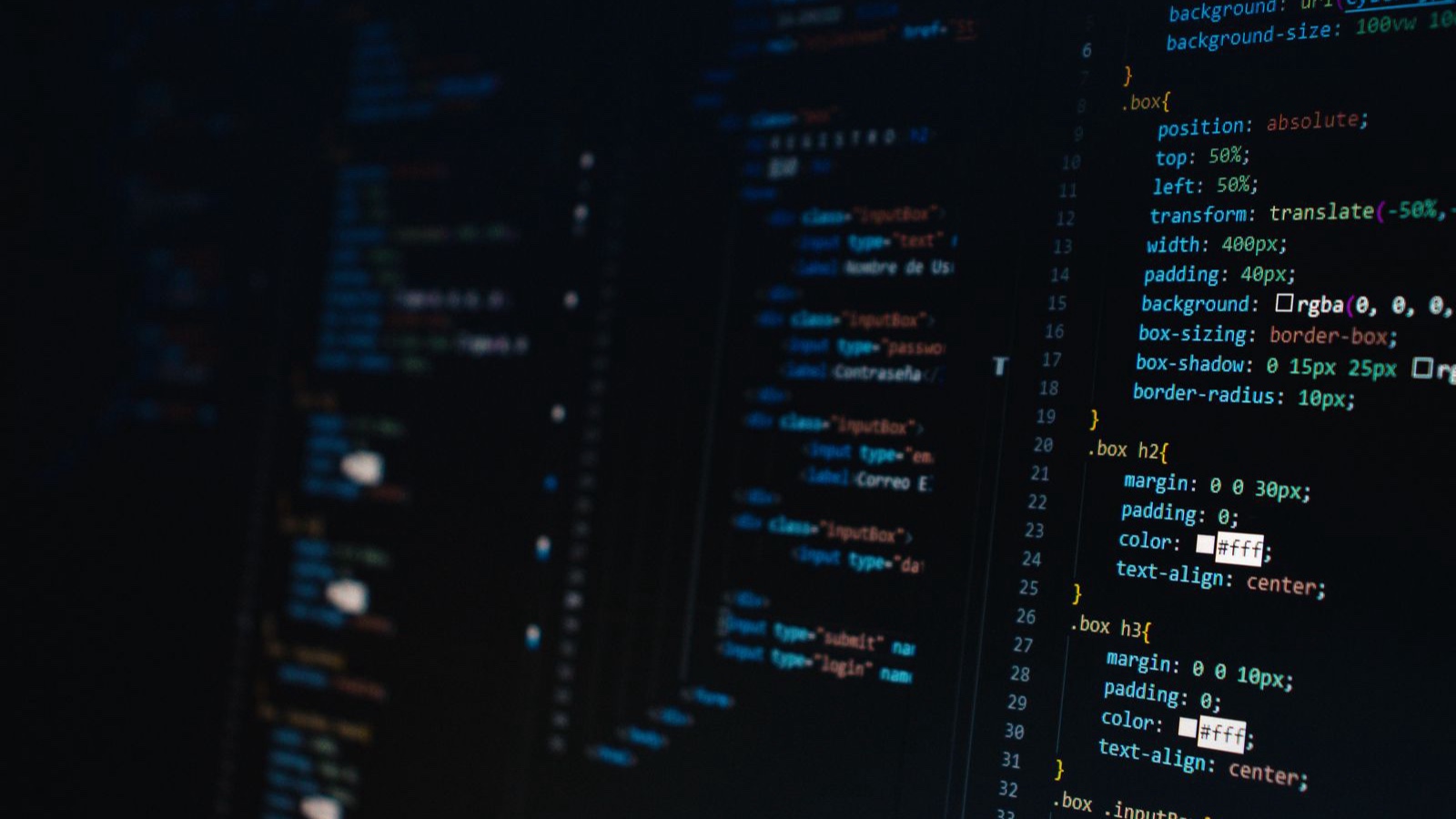 Website Speed: Where to Start with Core Web Vitals Detailed view of HTML and CSS code on a dark screen, representing modern web development.